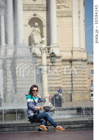 girl sitting with map and camera 30594145