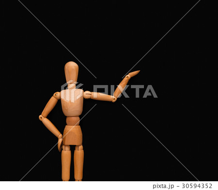 Wooden man point at black background Wooden man point at black background 30594352