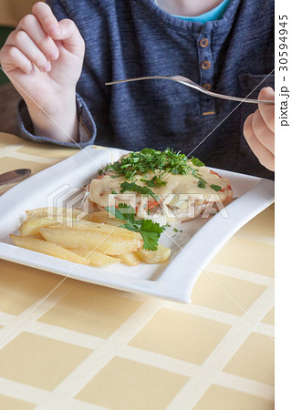 hands of the person eating the baked chicken hands of the person eating the baked chicken 30594945