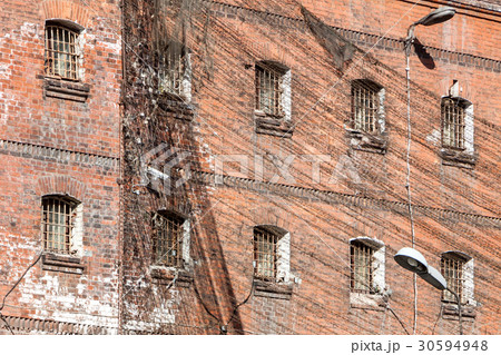 wall of prison with barred windows wall of prison with barred windows 30594948