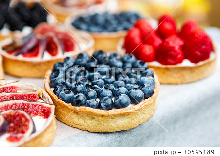 Closeup of blueberry tart dessert tray assorted 30595189