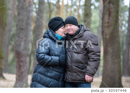 Old couple walking in the forest Old couple walking in the forest 30597446