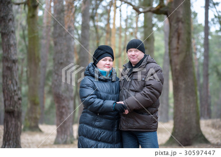 Old couple walking in the forest Old couple walking in the forest 30597447