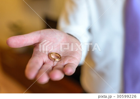 two wedding rings on grooms hand. 30599226