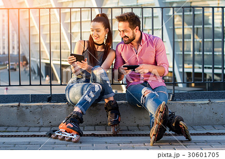 Smiling couple with cellphones. 30601705