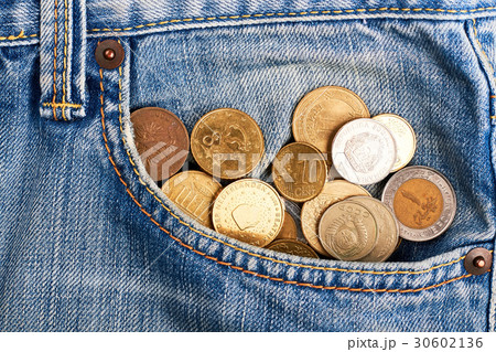 Coins in faded jeans. 30602136