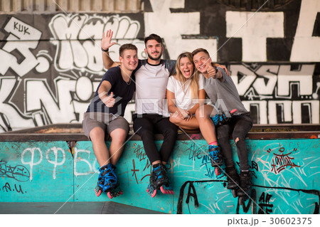 People on rollerblades smiling. 30602375