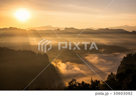 Scenic landscape sunlight shine on foggy hill 30603092