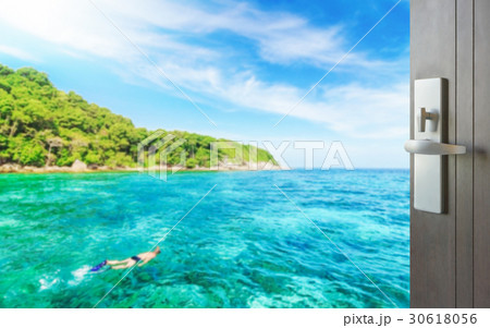 opened door to blue sea with tourist snorkeling 30618056
