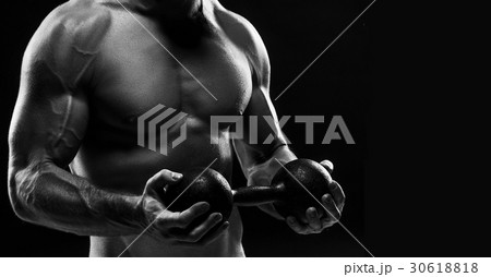 The torso of attractive male body builder on black 30618818