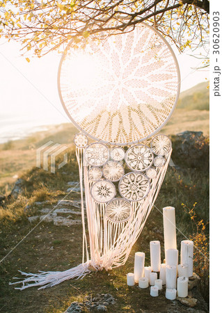 big white Dreamcatcher connected by a hook hanging 30620903