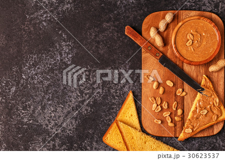 Bowl of peanut butter on wooden board. Bowl of peanut butter on wooden board. 30623537