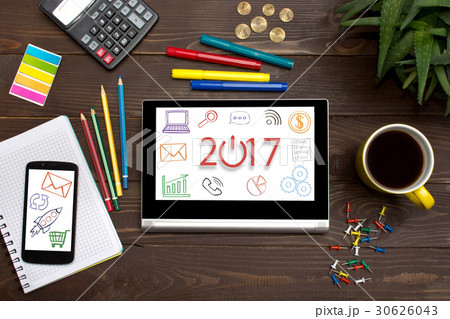 Tablet with web icon 2017 on a wooden table Tablet with web icon 2017 on a wooden table 30626043