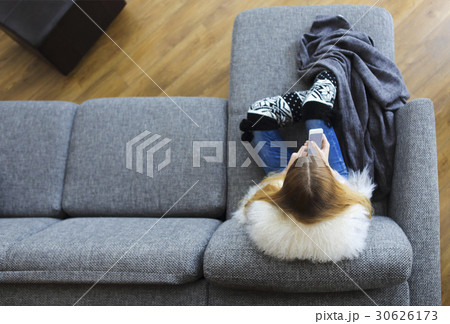 Woman writing a text message on her phone 30626173