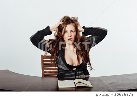 Sexy business woman shocked and looks in notebook Sexy business woman shocked and looks in notebook 30626378