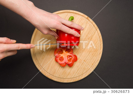 Slicing red pepper on chopping board Slicing red pepper on chopping board 30626873