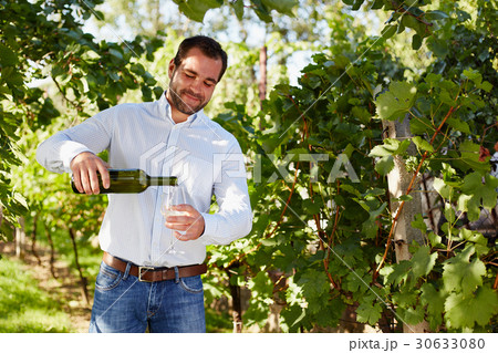 Man with a glass of white wine 30633080