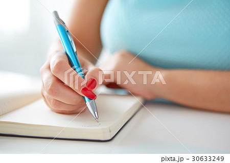 Young woman writes to black diary 30633249