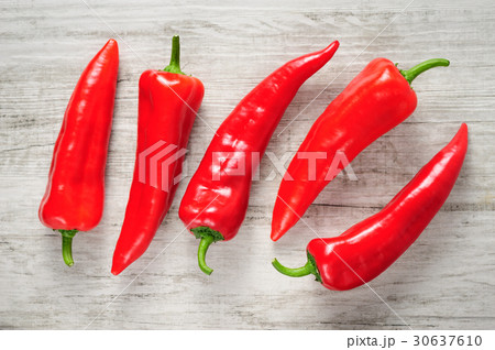 Sweet red Kapia peppers on a white wood background 30637610