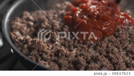 roasting minced beef with tomato paste in a pan roasting minced beef with tomato paste in a pan 30637623