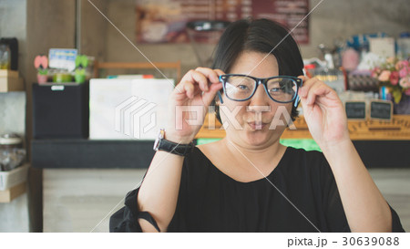 Asia women with eye glasses in coffee shop 30639088