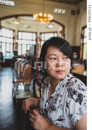 Asian women turn face in coffee shop vintage style 30639211