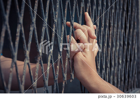 Hands of the man and woman on a steel lattice 30639603