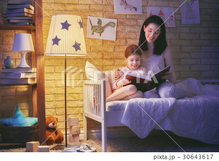 Family reading bedtime. 30643617