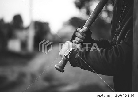 hooligan with the baseball bat ready to attack 30645244