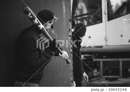 hooligan with the baseball bat ready to attack 30645249