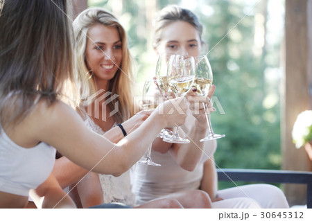 Happy friends toasting wine 30645312