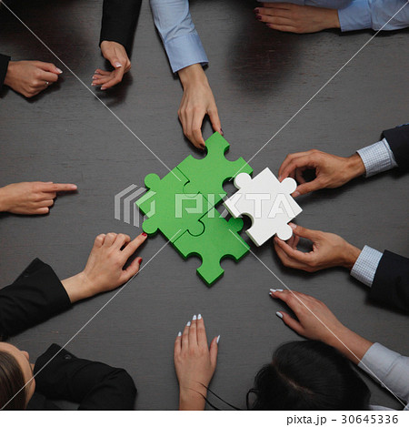 Business people assembling puzzle 30645336