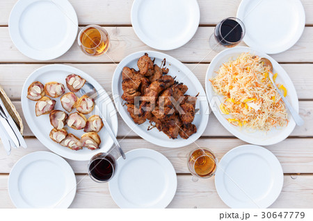 Dinner table with barbecue meat chops and salad Dinner table with barbecue meat chops and salad 30647779