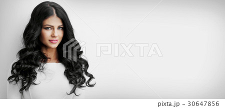 Beautiful brunette with long curly hair Beautiful brunette with long curly hair 30647856