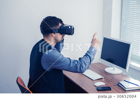 Young businessman in vr glasses drawing chart with 30652004