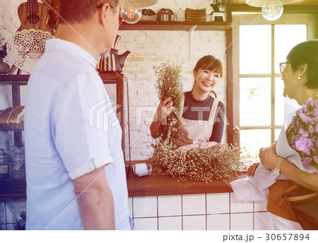 Young florist woman decorating flower bouquet 30657894