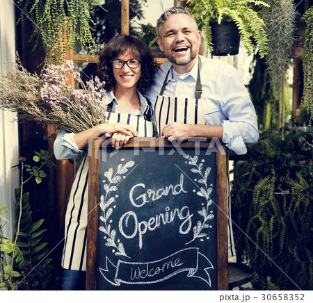 Adult Man and Woman Standing with Grand Opening Sign 30658352