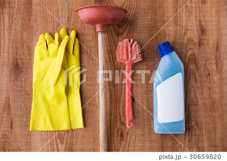 plunger with cleaning stuff on wooden background plunger with cleaning stuff on wooden background 30659820