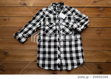 checkered shirt with tag on wooden background checkered shirt with tag on wooden background 30660266