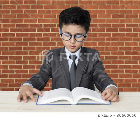 A Caucasian Boy With Glasses Reading Book Background Studio Portrait 30660650