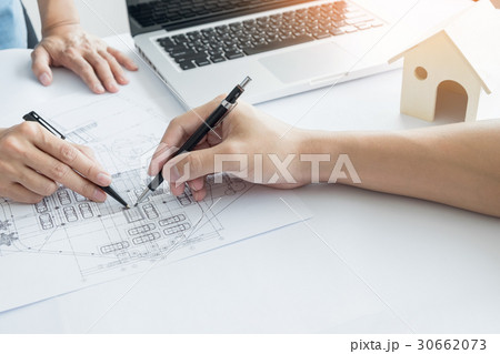 Architects engineer discussing at the table with blueprint - Clo 30662073