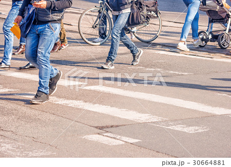 people crossing the pedestrian crossing 30664881