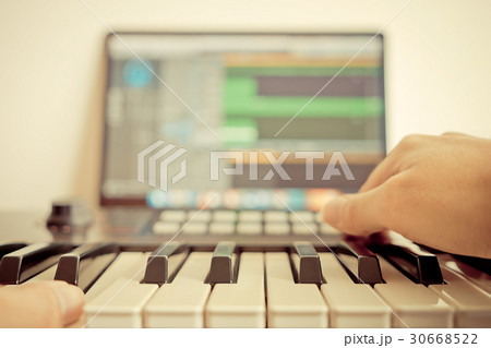 keyboard player is recording on DAW music station 30668522