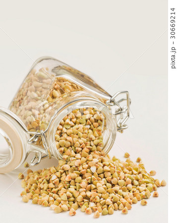 Raw green buckwheat in bank on white background 30669214
