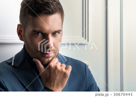 Thoughtful young stylish guy with stubble 30670443