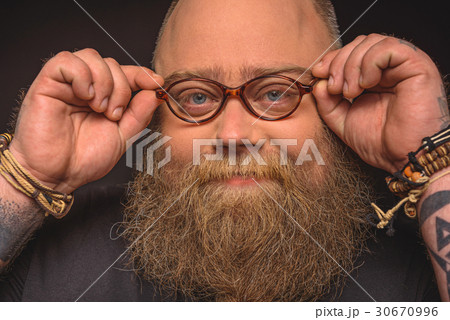 Male fatso with eyeglasses making serious decision 30670996