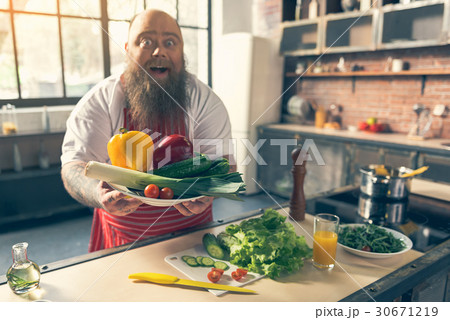 Excited male fatso showing healthy food 30671219