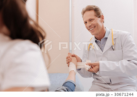 Pleasant friendly doctor fixating kids joints Pleasant friendly doctor fixating kids joints 30671244