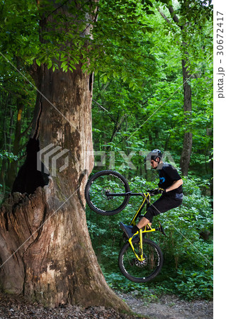 Man bikes in the green forest. Man bikes in the green forest. 30672417