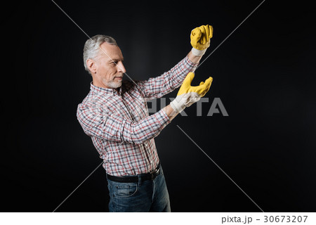 Attentive man wearing rubber gloves Attentive man wearing rubber gloves 30673207
